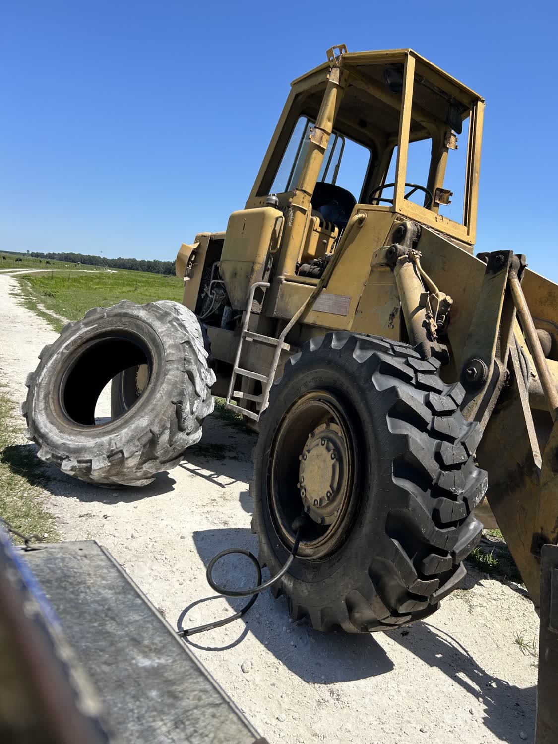 Wheel loader tire replacement on a farm road near Bronson FL